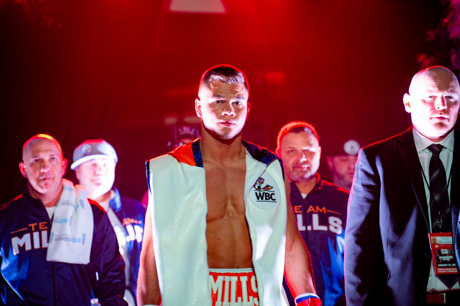A fighter walking out with his team under red light