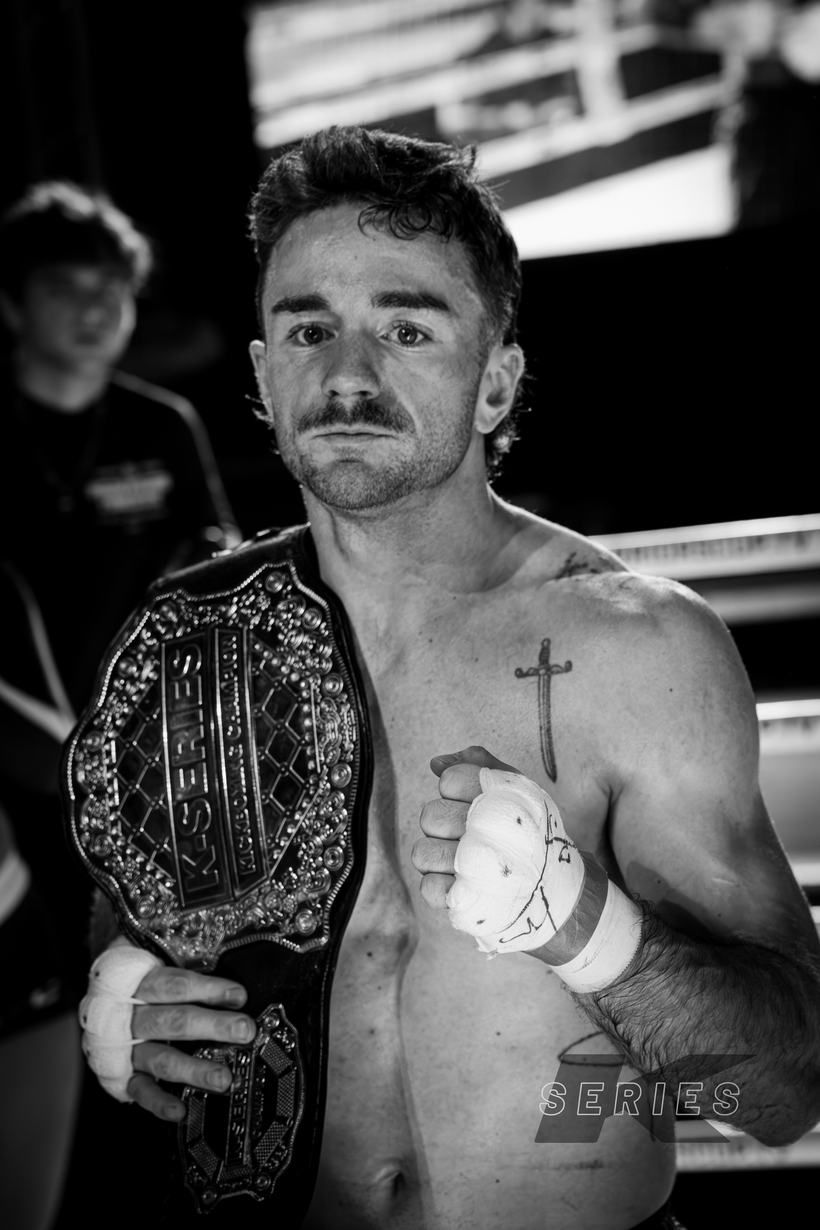 Champion with the belt over his shoulder after the fight