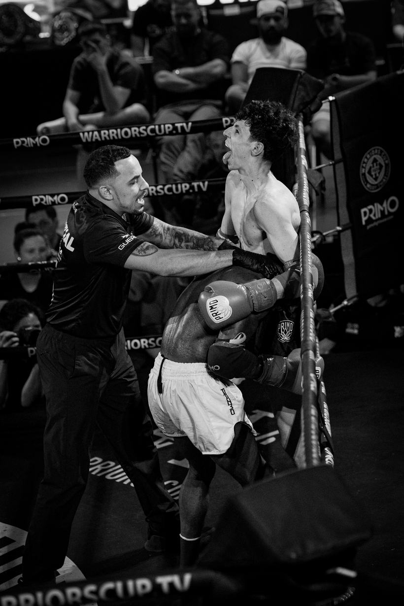 Cornerman grabbing a shouting fighter at the ropes