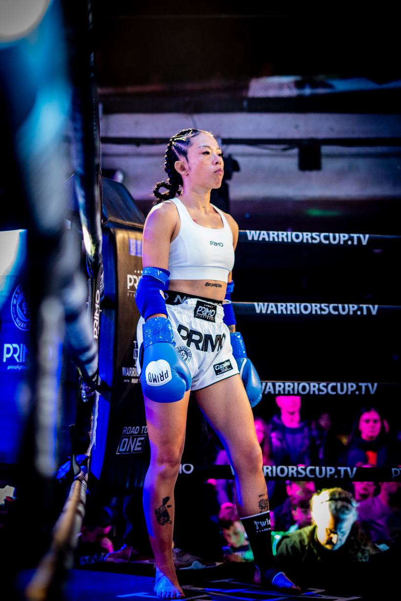 Muay Thai fighter walking out under the arena lights