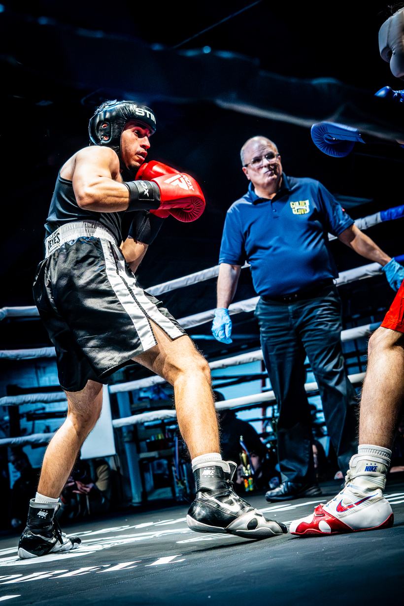 Fighter squared up in his guard as the referee looks on