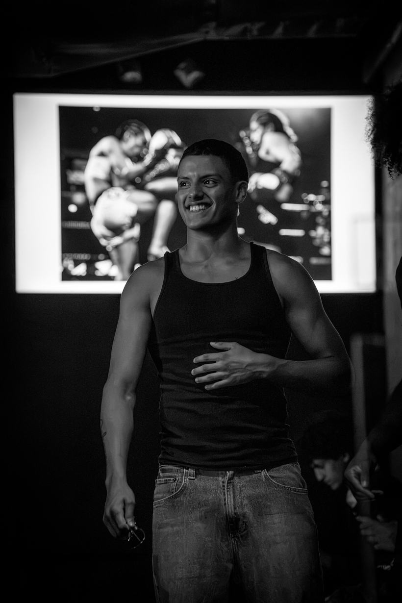 Guest smiling and gesturing beside the replay screen