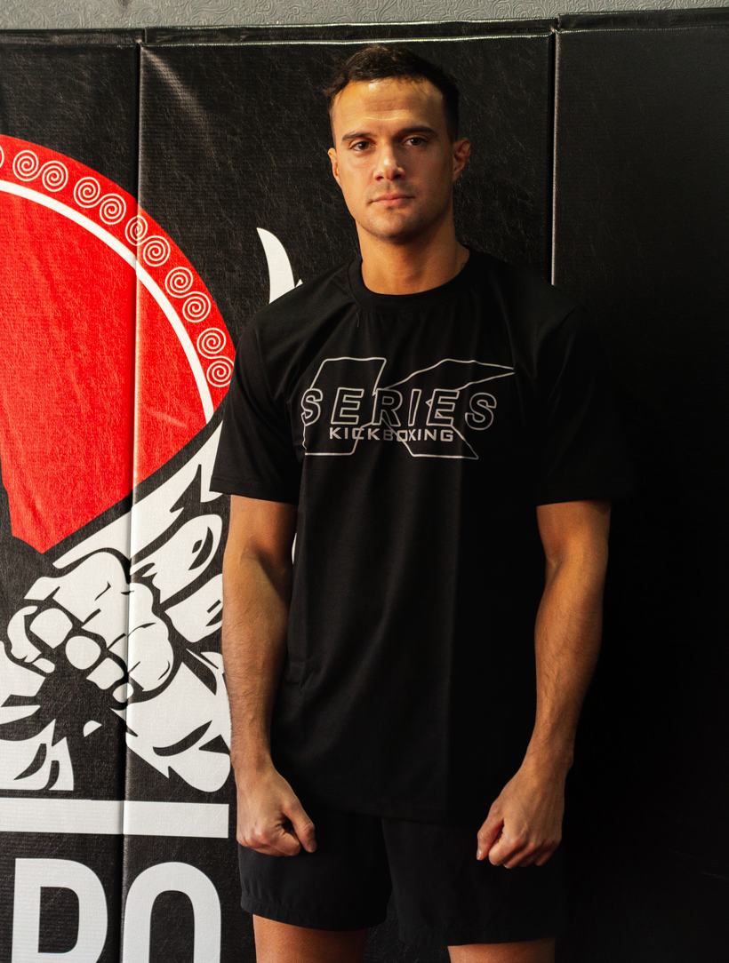 Fighter posed in a kickboxing team shirt