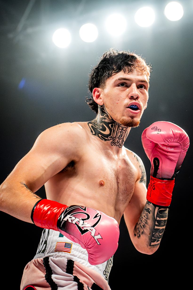 Boxer set in his stance under the arena lights
