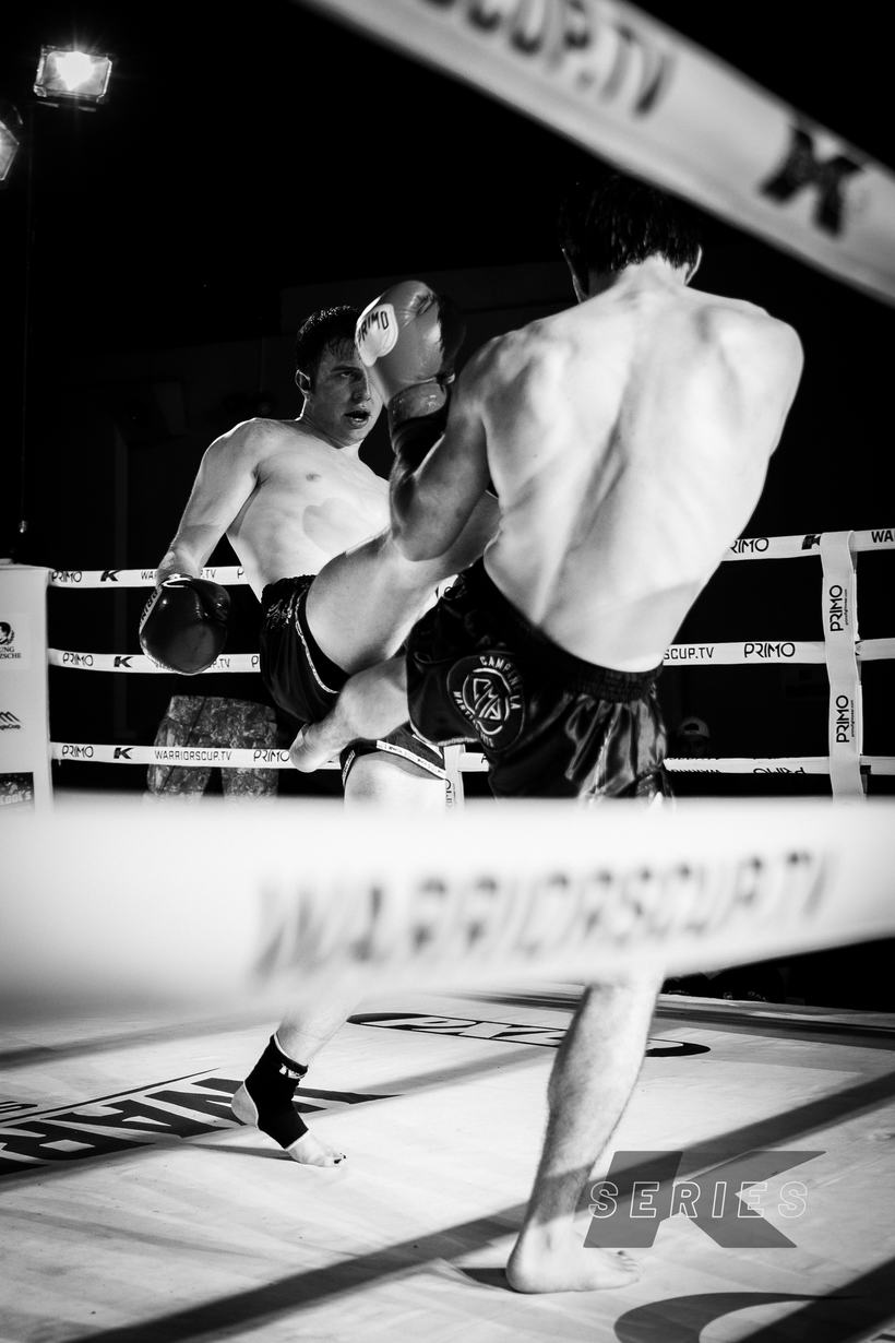 Kick landing high under the ring lights
