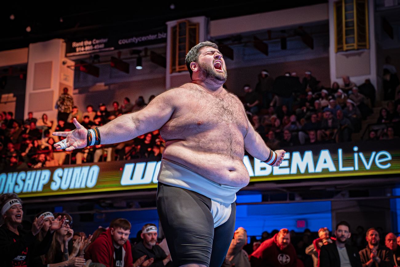 Heavyweight wrestler roaring to the crowd after the win