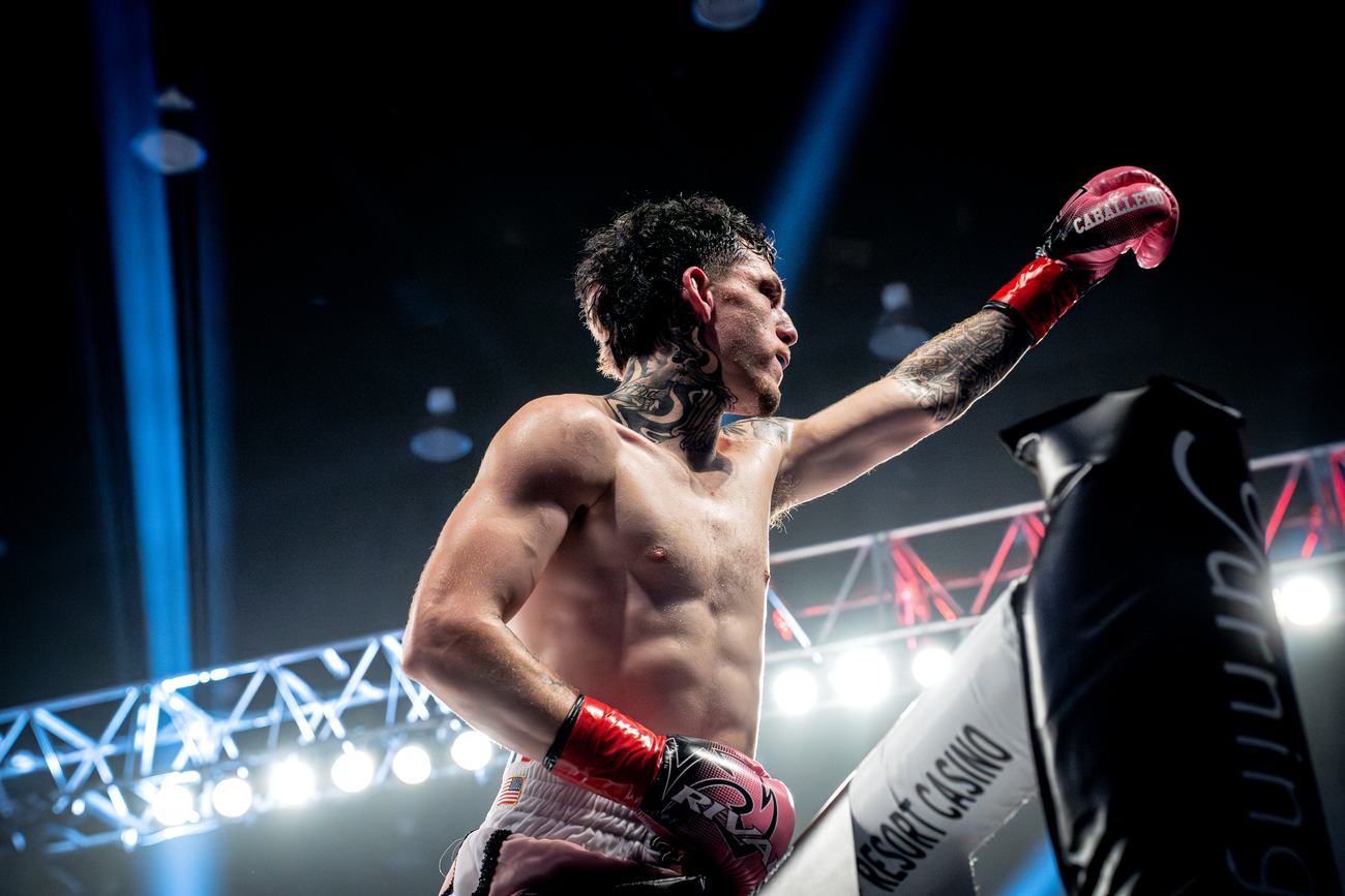 Fighter reaching to touch gloves with the corner pad