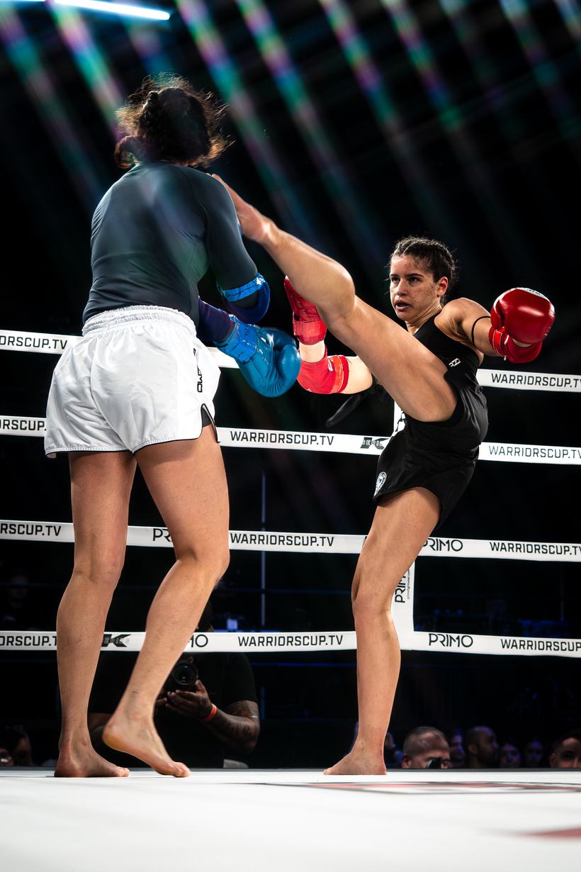Head kick landing between two Muay Thai fighters