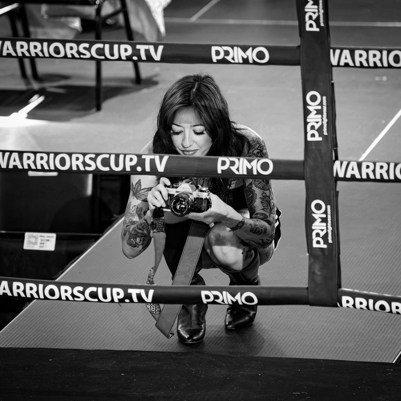 Photographer crouched on the ring apron mid shot