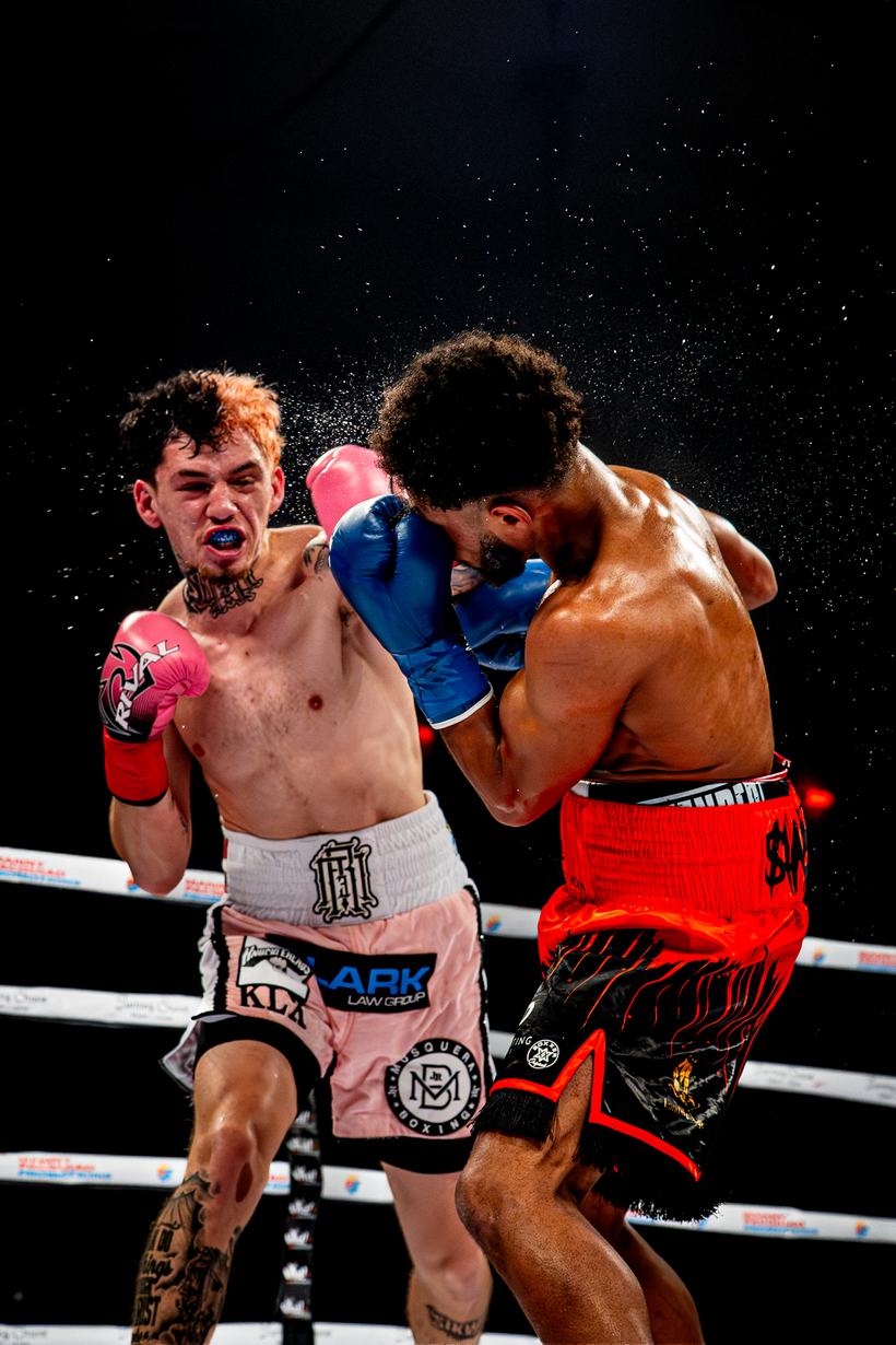 Punch landing clean, sweat coming off the impact