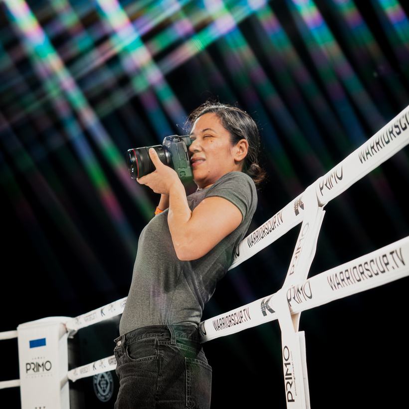 Photographer shooting through the ropes at ringside