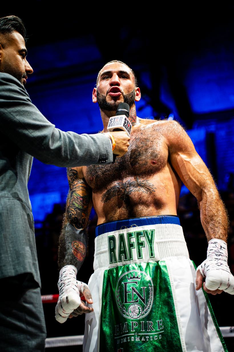 Boxer interviewed after the win, still gloved up