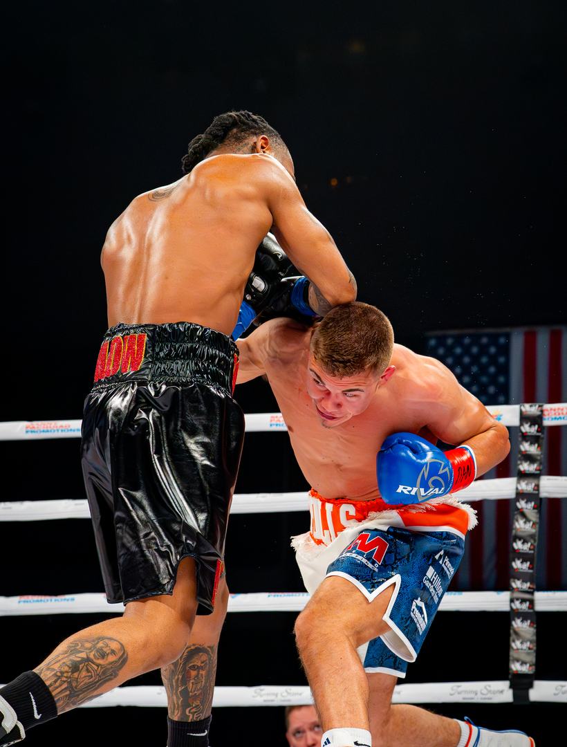 Body shot digging in against the ropes