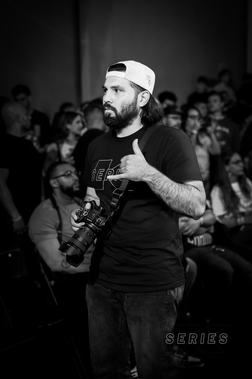 Photographer backstage with his camera, pointing