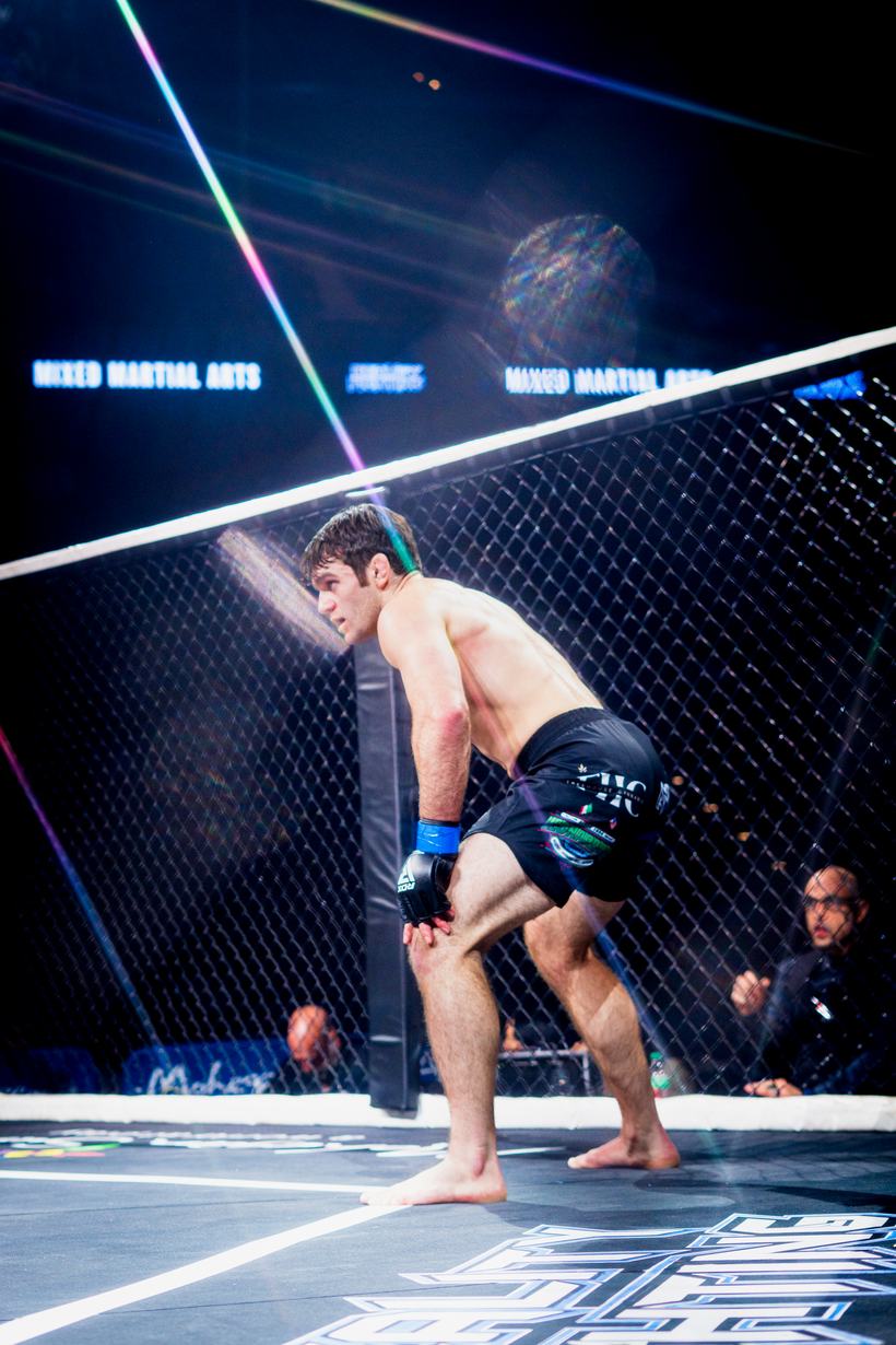 Kick thrown against the cage wall