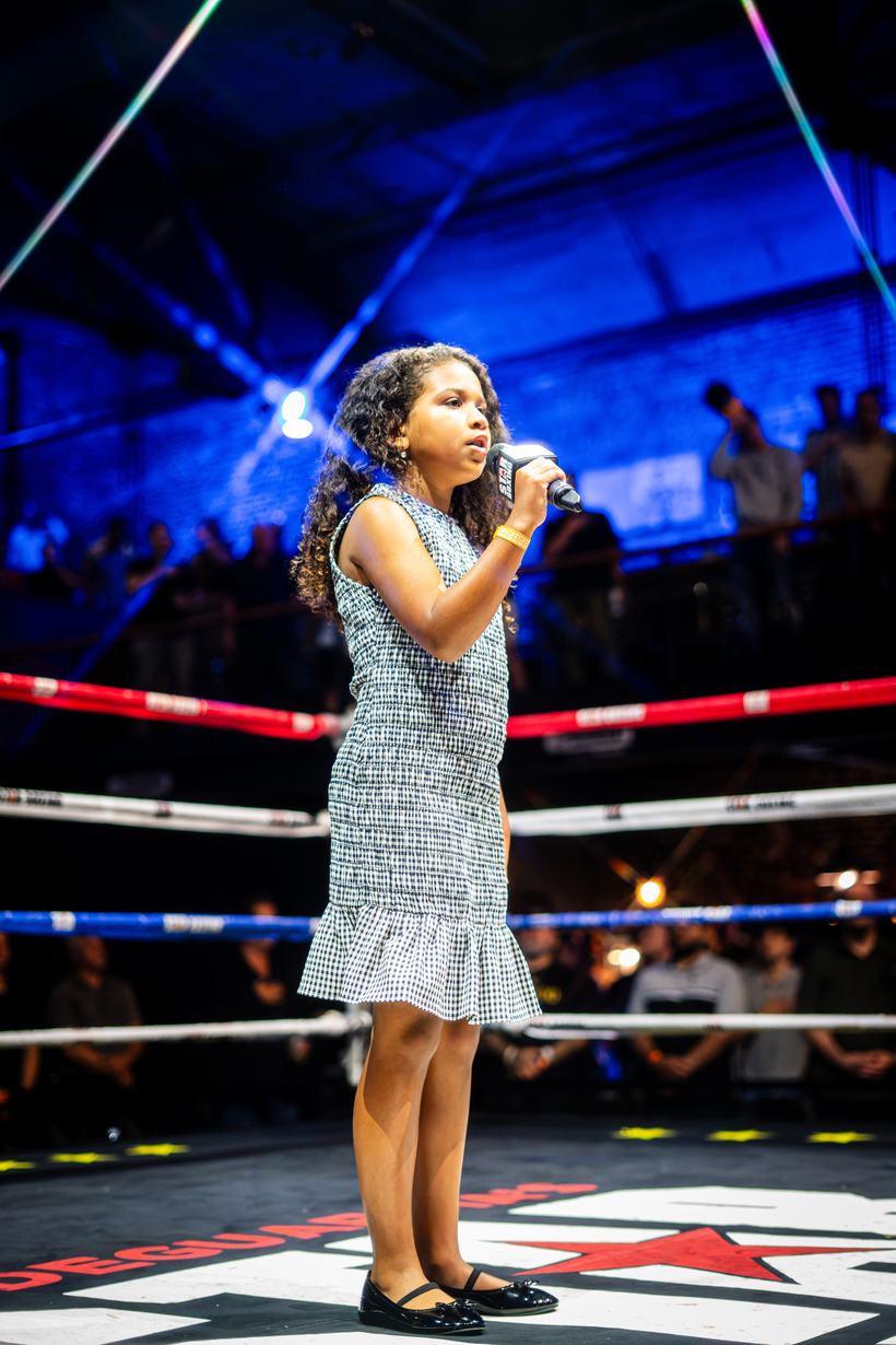 Young singer performing the anthem before the card