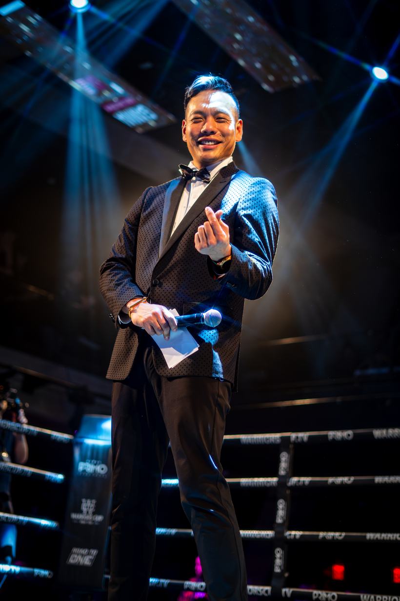 Announcer in a tuxedo working the microphone