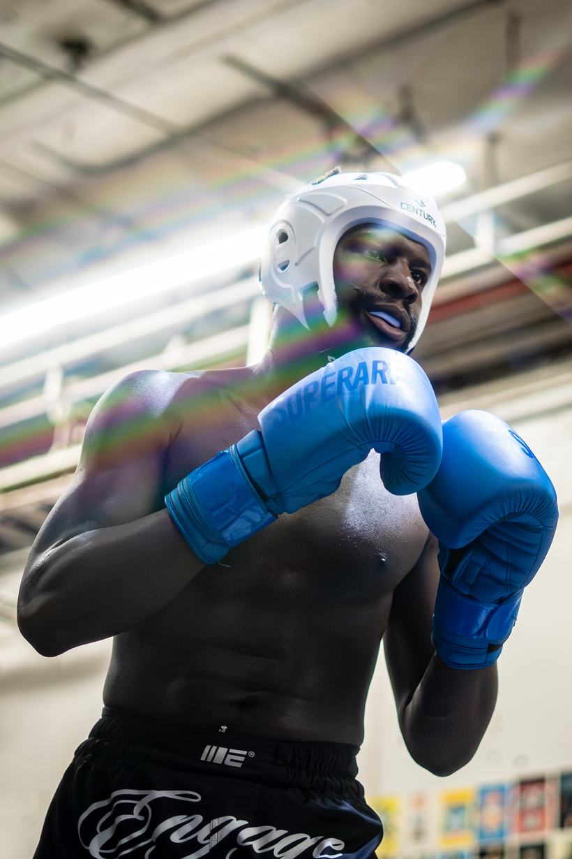 Boxer in headgear working through a sparring round