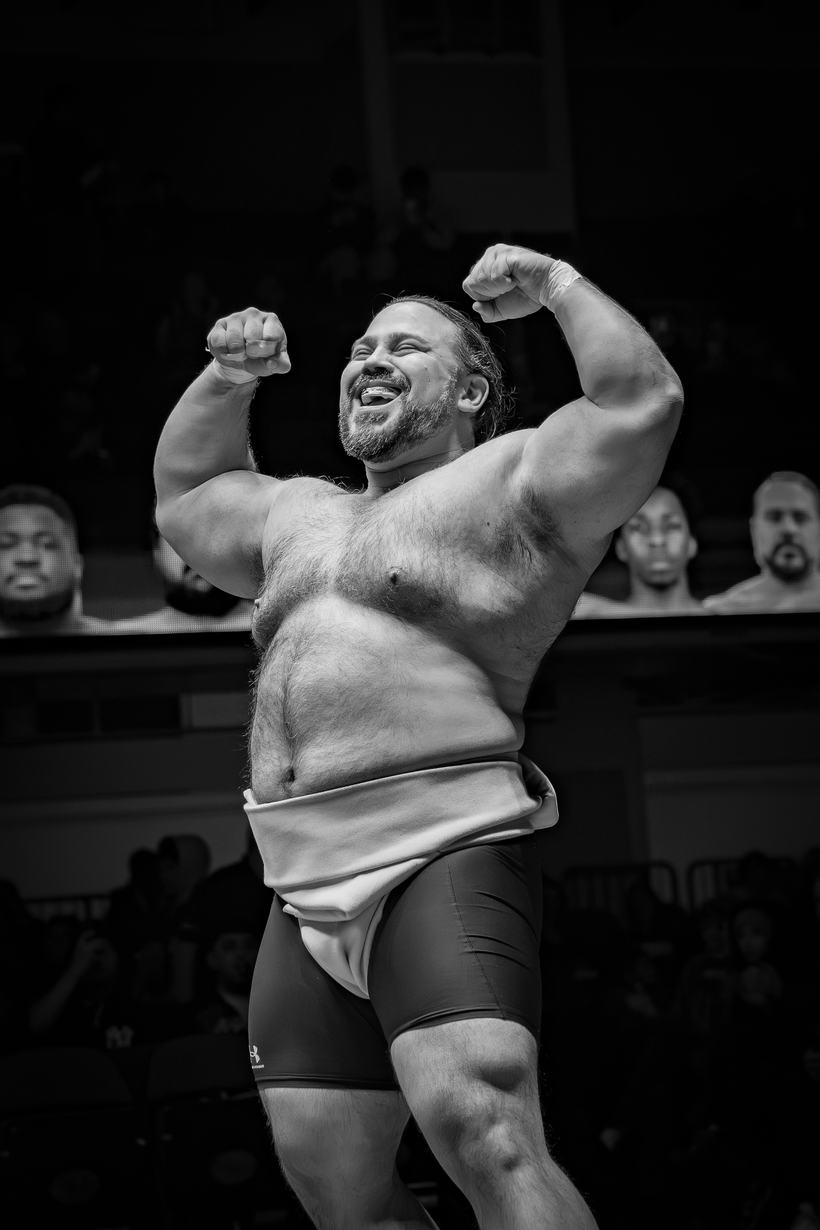 Wrestler flexing to the crowd after taking the bout