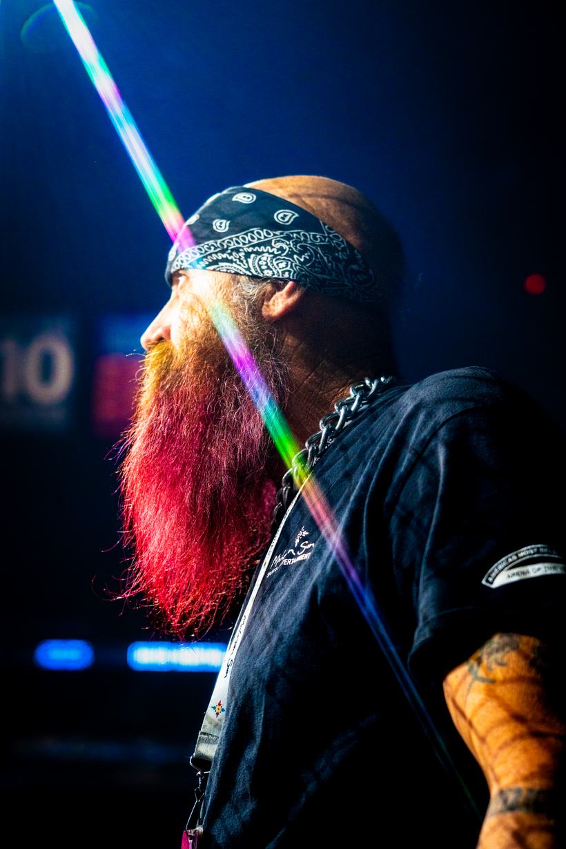 Bearded fan with a dyed red beard lit by a laser line