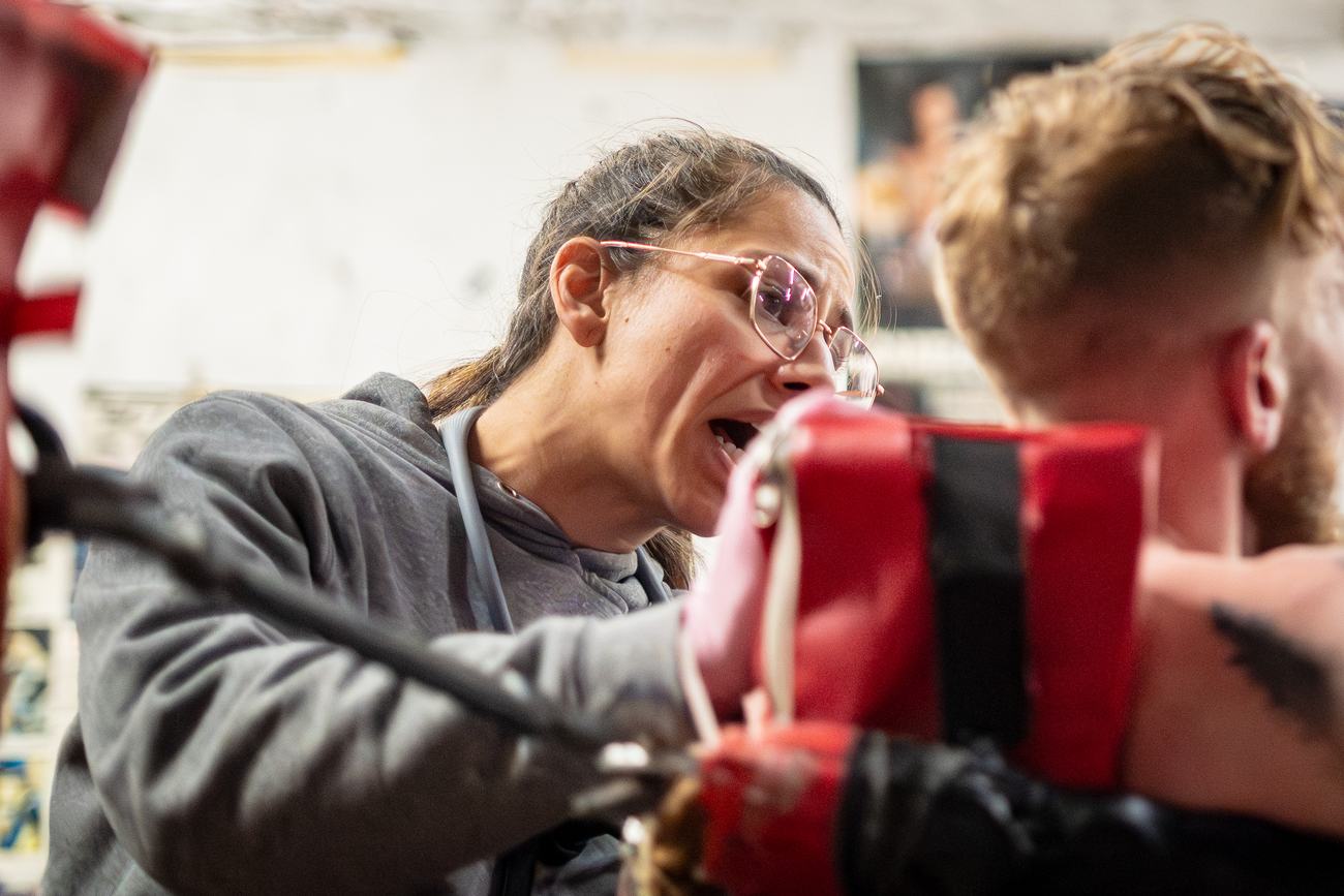 Coach barking instructions behind the focus mitts
