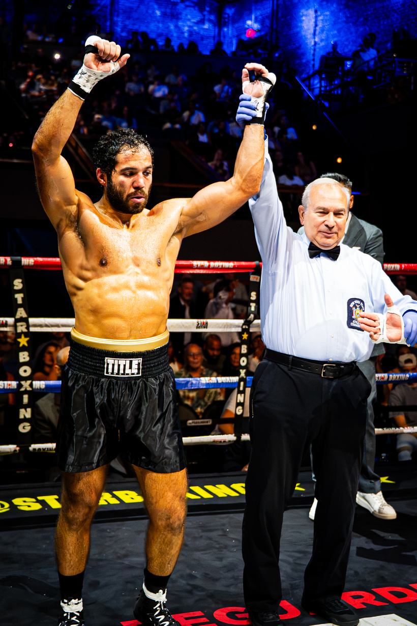 Referee raising the winning boxer's hand